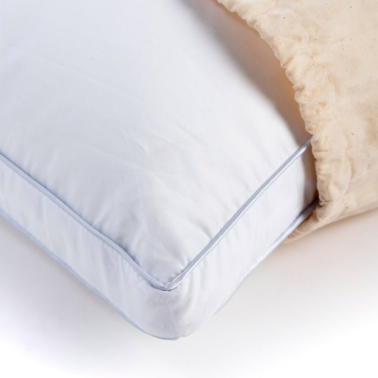 White 'Comfi' pillow close up inside a beige pillow bag.